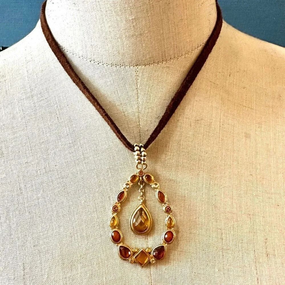 Gold tone and orange teardrop rhinestone pendant necklace on cord